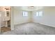 Attached bathroom features decorative sink and two windows at 13805 W 82Nd Ave, Arvada, CO 80005