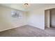 Bedroom with neutral walls, carpeted floor, window, and doorway to another room at 13805 W 82Nd Ave, Arvada, CO 80005