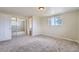 Bedroom features neutral walls, large window, and closet with mirrored doors at 13805 W 82Nd Ave, Arvada, CO 80005