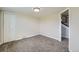 Carpeted bedroom with closet, stairs, and neutral paint at 13805 W 82Nd Ave, Arvada, CO 80005