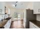 Bright kitchen with white cabinets, stainless steel appliances, and a sliding door to backyard at 13805 W 82Nd Ave, Arvada, CO 80005