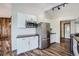 Modern kitchen with stainless steel appliances, white cabinetry, and hardwood floors at 13805 W 82Nd Ave, Arvada, CO 80005
