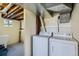 Basement laundry area includes a washer and dryer with utility sink at 13805 W 82Nd Ave, Arvada, CO 80005