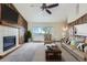 Inviting living room with a fireplace, wood-paneled accent walls, and comfortable seating at 13805 W 82Nd Ave, Arvada, CO 80005