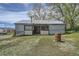 Exterior view of backyard shed with a metal roof and open doors surrounded by a grassy area at 13805 W 82Nd Ave, Arvada, CO 80005