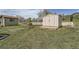 Exterior view of a shed in a grassy backyard featuring metal doors and concrete base at 13805 W 82Nd Ave, Arvada, CO 80005