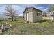 Exterior view of a shed in a grassy backyard, with a gabled roof and horizontal siding at 13805 W 82Nd Ave, Arvada, CO 80005