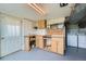 Basement workshop area featuring built-in cabinets and storage space, plus a door for easy access at 13805 W 82Nd Ave, Arvada, CO 80005