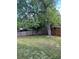 Green backyard with a wood fence, green lawn, shade trees, and stone pavers for an added natural landscape at 1477 S Wright Ct, Lakewood, CO 80228