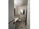 Bathroom featuring tile walls, white fixtures and dark red accents, giving the room charm at 1477 S Wright Ct, Lakewood, CO 80228