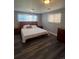 A bedroom showcasing wood-style floors, light from the windows, and and dressers at 1477 S Wright Ct, Lakewood, CO 80228