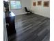 Bright bedroom with hardwood flooring, large window, office desk, and black office chair at 1477 S Wright Ct, Lakewood, CO 80228