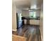 Modern kitchen with stainless steel appliances, white cabinets, and dark countertops at 1477 S Wright Ct, Lakewood, CO 80228