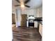 Modern kitchen with stainless steel appliances, white cabinets, and dark countertops at 1477 S Wright Ct, Lakewood, CO 80228