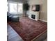 Cozy living room with fireplace, large window, accent rug, and comfortable seating at 1477 S Wright Ct, Lakewood, CO 80228