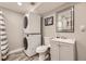 Functional bathroom featuring a modern vanity, toilet, mirror, and stacked washer and dryer for added convenience at 1477 S Wright St, Lakewood, CO 80228