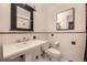 Bathroom featuring a vintage sink, medicine cabinet, white tiling and black and red accents at 1477 S Wright St, Lakewood, CO 80228