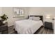 Cozy bedroom with natural light, hardwood floors, a soft bed and a bedside table at 1477 S Wright St, Lakewood, CO 80228