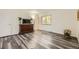 This room has hardwood flooring, a dresser with a TV on top, and a view out the window at 1477 S Wright St, Lakewood, CO 80228