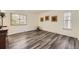 Bright bedroom featuring new hardwood flooring, windows, and tasteful decor at 1477 S Wright St, Lakewood, CO 80228