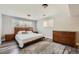 Bedroom features hardwood floors, a large bed, and a large dresser at 1477 S Wright St, Lakewood, CO 80228