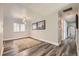 Minimalist dining room with modern light fixture and a clean, open space with wood grain vinyl flooring at 1477 S Wright St, Lakewood, CO 80228