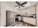 Modern kitchen with stainless steel appliances, white cabinets, and stylish wood-look vinyl flooring at 1477 S Wright St, Lakewood, CO 80228