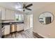 Modern kitchen with stainless steel appliances, ample white cabinetry, and a sleek ceiling fan at 1477 S Wright St, Lakewood, CO 80228