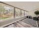 Bright sunroom with large windows offering serene backyard views, complete with elegant flooring and modern decor at 1477 S Wright St, Lakewood, CO 80228