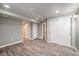 The finished basement has wood grain floors, recessed lighting, and multiple doors at 6876 Edgewood Way, Highlands Ranch, CO 80130