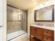 Basement bathroom featuring glass shower, stone tile, granite vanity and modern fixtures at 6876 Edgewood Way, Highlands Ranch, CO 80130