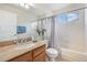 Bathroom features a granite-topped vanity, ceramic tile, tub, shower, and window at 6876 Edgewood Way, Highlands Ranch, CO 80130