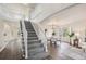 Inviting entryway with staircase, neutral paint, and plenty of natural light flowing into the adjacent dining area at 6876 Edgewood Way, Highlands Ranch, CO 80130