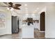 Bright kitchen with stainless steel appliances, white cabinetry, central island, and modern countertops at 6876 Edgewood Way, Highlands Ranch, CO 80130