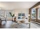 Open-concept living room featuring neutral decor, modern furnishings, and lots of natural light at 6876 Edgewood Way, Highlands Ranch, CO 80130