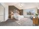 Comfortable main bedroom with neutral colors, natural light, and an en-suite bathroom at 6876 Edgewood Way, Highlands Ranch, CO 80130