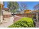 Private backyard with artificial turf, a wooden fence, and a patio area perfect for relaxing and entertaining at 4560 Flanders Way, Denver, CO 80249