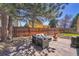 Landscaped backyard with outdoor seating, a fire pit, and a grill at 4560 Flanders Way, Denver, CO 80249
