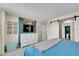 Bedroom with a dresser, TV, and a sliding door entry to the bathroom at 4560 Flanders Way, Denver, CO 80249