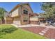 Back exterior showcases a backyard with seating, a hot tub, and artificial grass at 4560 Flanders Way, Denver, CO 80249