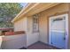 Front door with white trim, a charming window and a storm door at 4560 Flanders Way, Denver, CO 80249