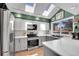 Modern kitchen features stainless steel appliances, granite counters, and white marble backsplash and skylights at 4560 Flanders Way, Denver, CO 80249
