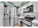 Modern kitchen features stainless steel appliances, granite counters, and white marble backsplash at 4560 Flanders Way, Denver, CO 80249