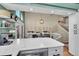 Open kitchen with a marble countertop, modern appliances, and views of the dining area at 4560 Flanders Way, Denver, CO 80249