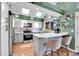 Bright kitchen featuring white cabinets, gray island, stainless steel appliances and skylights at 4560 Flanders Way, Denver, CO 80249