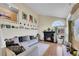 Bright living room with a cozy fireplace, large window and comfortable sectional sofa at 4560 Flanders Way, Denver, CO 80249