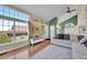 Inviting living room with lots of natural light from the large window and vaulted ceiling with ceiling fan at 4560 Flanders Way, Denver, CO 80249