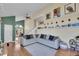 Bright living room with a large sectional sofa, hard wood floors and an open floor plan at 4560 Flanders Way, Denver, CO 80249