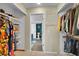 Walk-in closet view with shelving, hanging racks, and a peek into an attached bathroom at 4560 Flanders Way, Denver, CO 80249