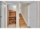 Basement staircase leads to a wine cellar featuring a wooden wine rack at 4560 Flanders Way, Denver, CO 80249